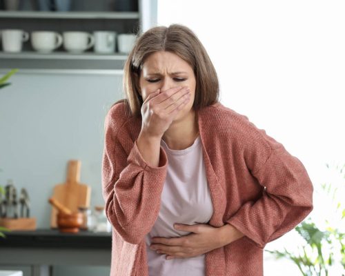 Pregnant woman suffering from toxicosis at home